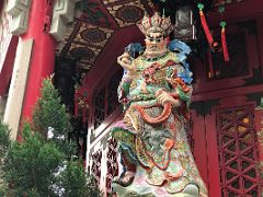 11D Statue of the heavenly king of the west holds a red dragon Yue Heung Shrine at Wong Tai Sin temple Hong Kong